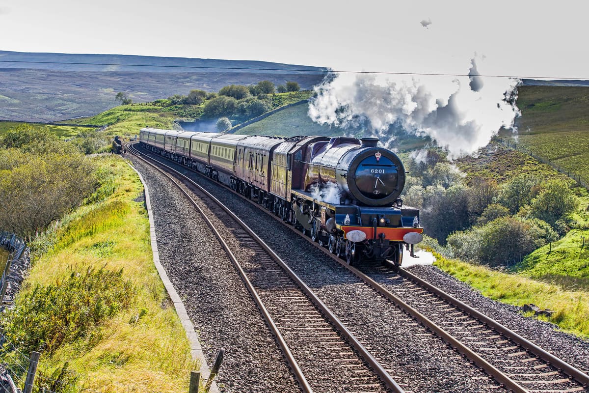 Supplied archive photograph of Northern Belle carriages behind a steam locomotive in countryside